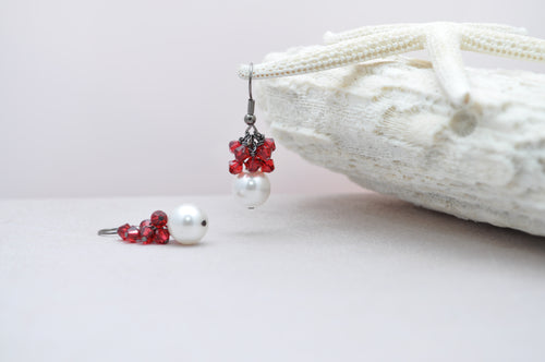 Elegant white pearl earrings with red accents